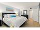This is a bright bedroom with wood floors and a queen-size bed with a view to the open closet at 7625 Sun Island S Dr # 304, South Pasadena, FL 33707