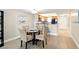 Cozy dining area adjacent to kitchen, featuring a modern table set and wood-look flooring at 7625 Sun Island S Dr # 304, South Pasadena, FL 33707
