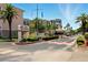 Inviting entrance to Bay Island with lush landscaping, signage, and a secure guardhouse at 7625 Sun Island S Dr # 304, South Pasadena, FL 33707