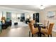 Open-concept living and dining area with sliding glass doors to balcony and water views at 7625 Sun Island S Dr # 304, South Pasadena, FL 33707