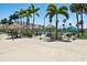 Inviting recreational area featuring tiki huts, picnic tables, grills, and tennis courts for outdoor enjoyment at 7625 Sun Island S Dr # 304, South Pasadena, FL 33707