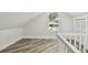 Bright attic space featuring wood-look floors, a window, and closet at 816 9Th Sw Ave, Largo, FL 33770