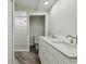 Bathroom featuring a double vanity, separate toilet room, and a glass door shower at 816 9Th Sw Ave, Largo, FL 33770