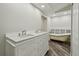 Bathroom featuring a double vanity, clawfoot bathtub, and wood-look tile flooring at 816 9Th Sw Ave, Largo, FL 33770