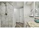 Bright bathroom with a marble-tiled shower, granite countertop, and updated fixtures at 816 9Th Sw Ave, Largo, FL 33770