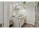 Well-lit bathroom with a large mirror, granite countertop, and ample storage space at 816 9Th Sw Ave, Largo, FL 33770