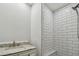 Modern bathroom with white subway tile shower and marble countertop, perfect for a luxurious experience at 816 9Th Sw Ave, Largo, FL 33770