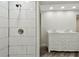 Modern bathroom with a tiled shower and a double vanity with ornate cabinetry at 816 9Th Sw Ave, Largo, FL 33770
