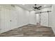 Spacious bedroom with light gray flooring and barn door to the bathroom at 816 9Th Sw Ave, Largo, FL 33770