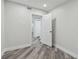Bright bedroom with wood-look floors, freshly painted walls, and a view into the hallway at 816 9Th Sw Ave, Largo, FL 33770
