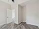 Clean bedroom with light-colored walls, vinyl flooring, baseboard, and doorway at 816 9Th Sw Ave, Largo, FL 33770