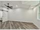 This bedroom features a modern ceiling fan, barn door, and sleek wood-look flooring at 816 9Th Sw Ave, Largo, FL 33770