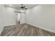 Bright bedroom with light-colored walls, vinyl flooring, and sliding barn door at 816 9Th Sw Ave, Largo, FL 33770