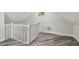 A finished bonus room features wood-look floors, fresh white paint, a small window, and stairs with white railings at 816 9Th Sw Ave, Largo, FL 33770