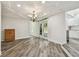 Open dining room area with wood-look flooring, contemporary lighting, and natural light at 816 9Th Sw Ave, Largo, FL 33770