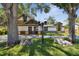 Beautiful home featuring unique architectural details, lush landscaping, and a well-manicured lawn at 816 9Th Sw Ave, Largo, FL 33770