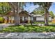 Charming craftsman home with a well-maintained lawn, mature trees, and a cozy front porch at 816 9Th Sw Ave, Largo, FL 33770