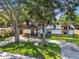 Charming craftsman home featuring a well-manicured lawn, beautiful mature trees, and unique architectural details at 816 9Th Sw Ave, Largo, FL 33770