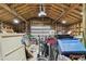 Cluttered garage with exposed rafters, tools, and storage at 816 9Th Sw Ave, Largo, FL 33770