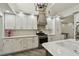 Modern white kitchen with stainless steel appliances and light wood flooring at 816 9Th Sw Ave, Largo, FL 33770