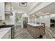 Bright kitchen with white cabinets, stainless steel appliances, and a large island at 816 9Th Sw Ave, Largo, FL 33770