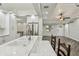 Modern kitchen featuring white cabinets, stainless steel appliances, and a view into the living room at 816 9Th Sw Ave, Largo, FL 33770