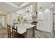 Open kitchen featuring bright skylight, white cabinets, and central island at 816 9Th Sw Ave, Largo, FL 33770