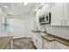 Modern kitchen boasts butcher block countertops, white cabinets, stainless appliances, and farmhouse sink at 816 9Th Sw Ave, Largo, FL 33770