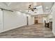 Spacious living room featuring modern flooring, ceiling fan and recessed lighting at 816 9Th Sw Ave, Largo, FL 33770