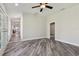 Spacious living room featuring luxury vinyl plank flooring and a modern ceiling fan at 816 9Th Sw Ave, Largo, FL 33770