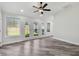 Spacious living room with a modern ceiling fan and multiple windows for ample natural light at 816 9Th Sw Ave, Largo, FL 33770
