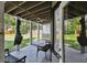 Inviting covered patio with ceiling fan, charming furniture and well-maintained yard at 816 9Th Sw Ave, Largo, FL 33770