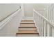 Bright staircase featuring wood treads and white railings, leading to upper level at 816 9Th Sw Ave, Largo, FL 33770