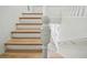 Staircase with wood treads and white risers, leading to upper floors in a bright, renovated home at 816 9Th Sw Ave, Largo, FL 33770