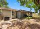 Private backyard features a screened-in porch, an AC Unit and mature trees for shade and relaxation at 8208 Volusia Pl, Tampa, FL 33637