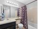 Neat bathroom with shower-tub combination, vanity with great storage, and large mirror at 8208 Volusia Pl, Tampa, FL 33637