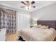 Bedroom with ceiling fan, light walls, and closet with sliding doors at 8208 Volusia Pl, Tampa, FL 33637