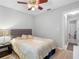 Cozy bedroom with light wood floors, ceiling fan, and neutral color palette for a calming space at 8208 Volusia Pl, Tampa, FL 33637