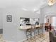 Breakfast bar featuring seating that looks into kitchen and into the dining area at 8208 Volusia Pl, Tampa, FL 33637