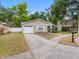 Charming single-story home features a well-maintained front yard and attached one-car garage at 8208 Volusia Pl, Tampa, FL 33637