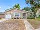 Charming single-Gathering home with a well-manicured lawn and inviting entryway on a sunny day at 8208 Volusia Pl, Tampa, FL 33637
