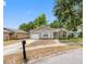 Beautiful single-story home with an attached one-car garage, and a manicured front yard at 8208 Volusia Pl, Tampa, FL 33637