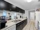 Functional kitchen with long countertops, dark cabinetry, and open layout for easy access at 8208 Volusia Pl, Tampa, FL 33637
