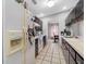 Efficient kitchen with appliances, tile backsplash, and access to dining area at 8208 Volusia Pl, Tampa, FL 33637