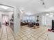 Open-concept living space with tile flooring, neutral walls, and seamless flow to the kitchen at 8208 Volusia Pl, Tampa, FL 33637