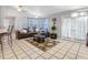 Open living room features a ceiling fan, tile flooring, and glass doors to backyard at 8208 Volusia Pl, Tampa, FL 33637
