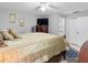 Comfortable main bedroom with ceiling fan, dresser, TV, and adjoining bathroom entrance at 8208 Volusia Pl, Tampa, FL 33637