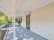 Covered balcony featuring wood railing and an exterior door at 8521 N 29Th St, Tampa, FL 33604