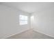 Carpeted bedroom features a window and doorway at 8521 N 29Th St, Tampa, FL 33604