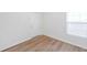 Bright bedroom with wood-look vinyl floors, white walls, and a window at 8521 N 29Th St, Tampa, FL 33604